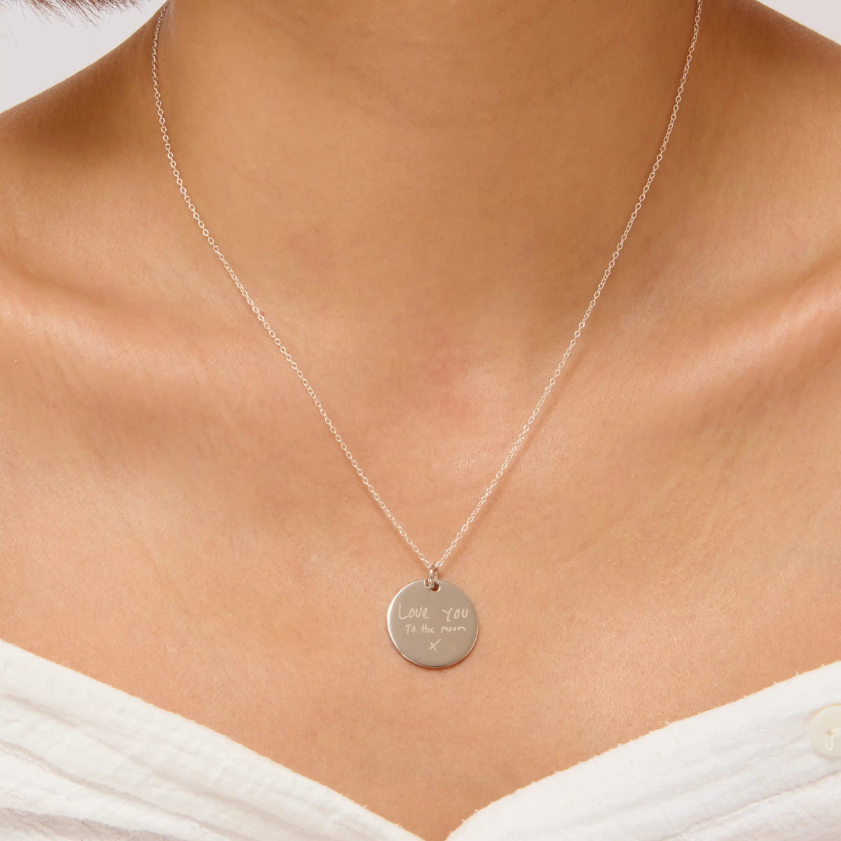Woman wearing a silver handwriting pendant necklace
