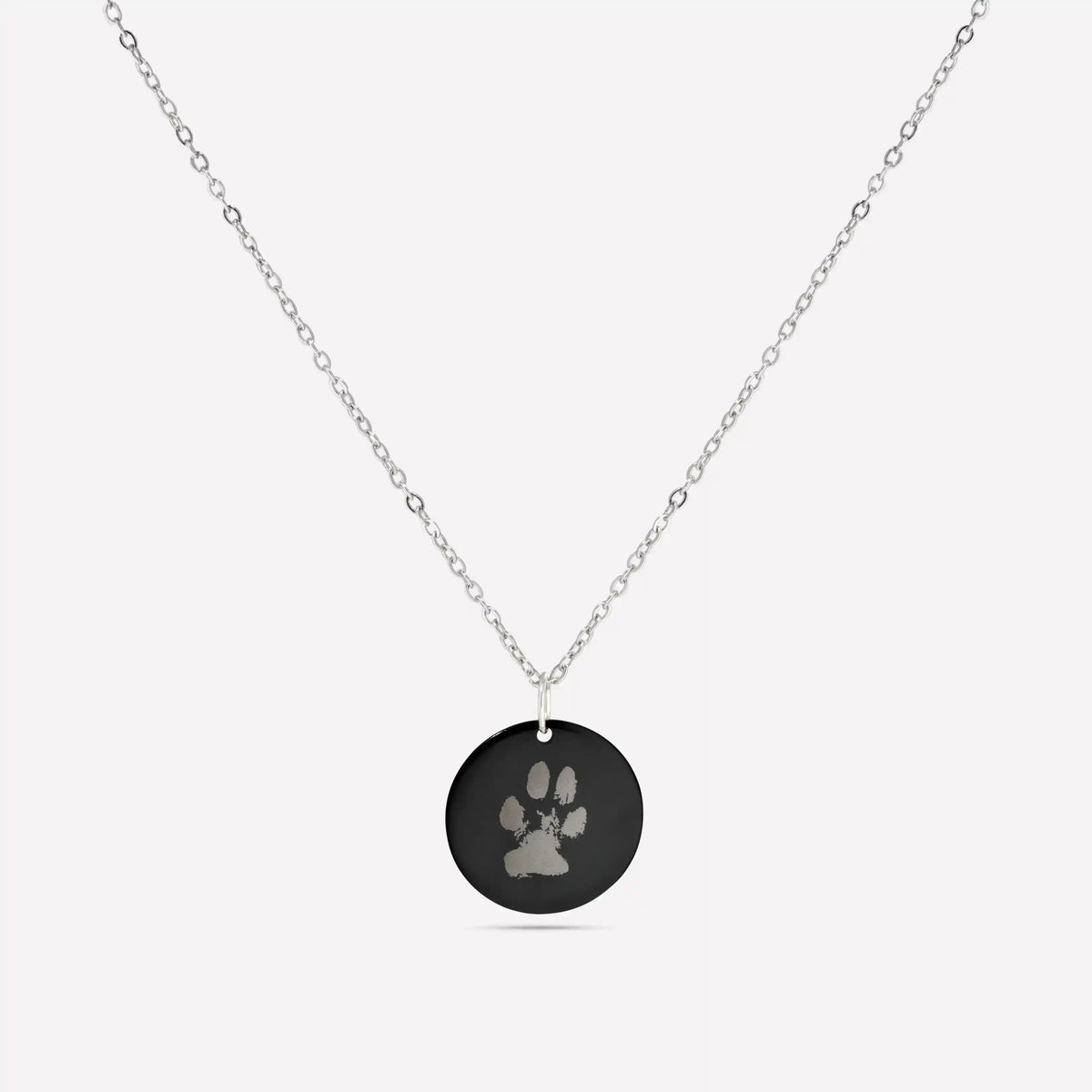 Black disc pendant necklace engraved with a pet paw print
