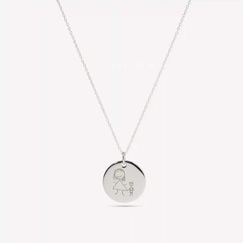 Silver pendant engraved with a child's drawing