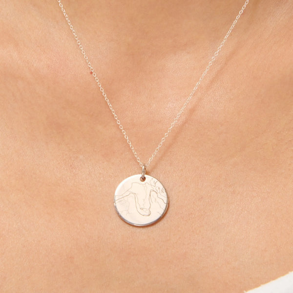 Silver street map pendant worn