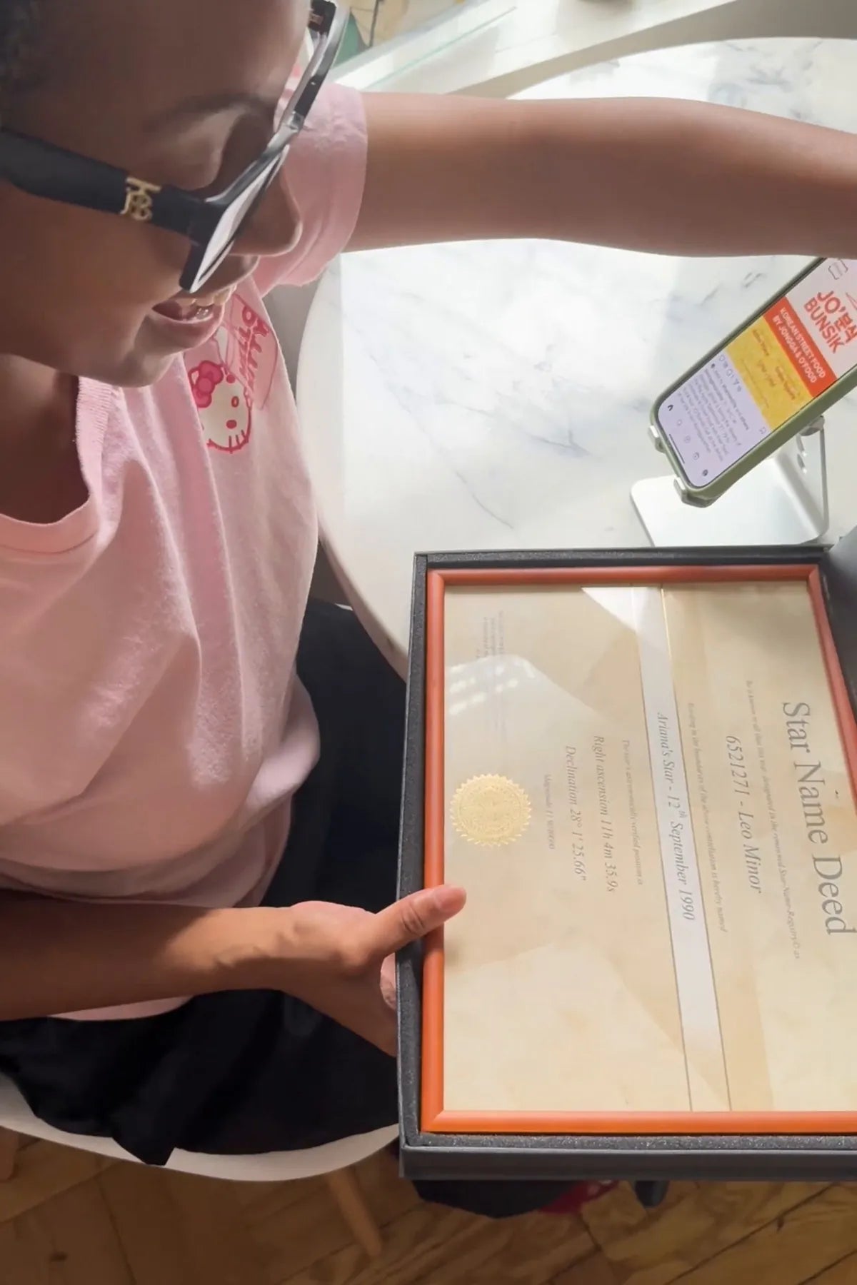 Man holding framed star certificate