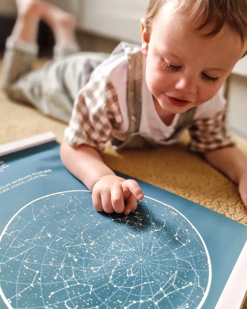 Child touching a teal star map