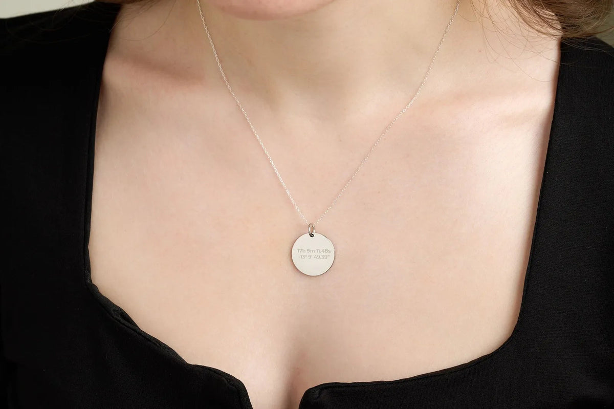 Close-up of a silver star map pendant