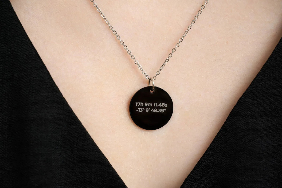 Back of an engraved star pendant showing coordinates