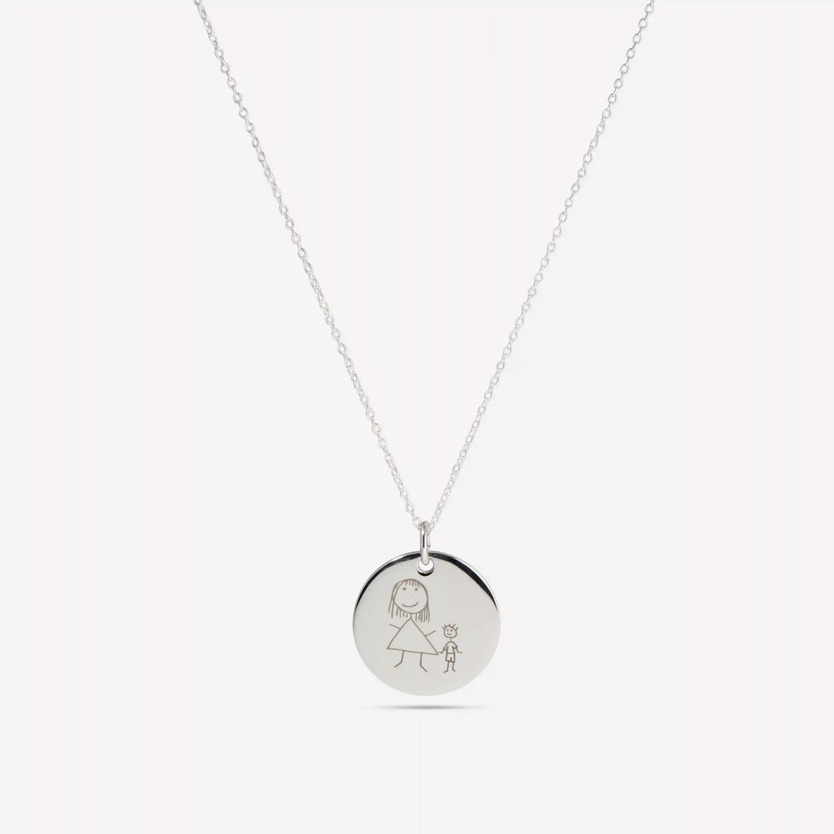 Silver pendant engraved with a child's drawing