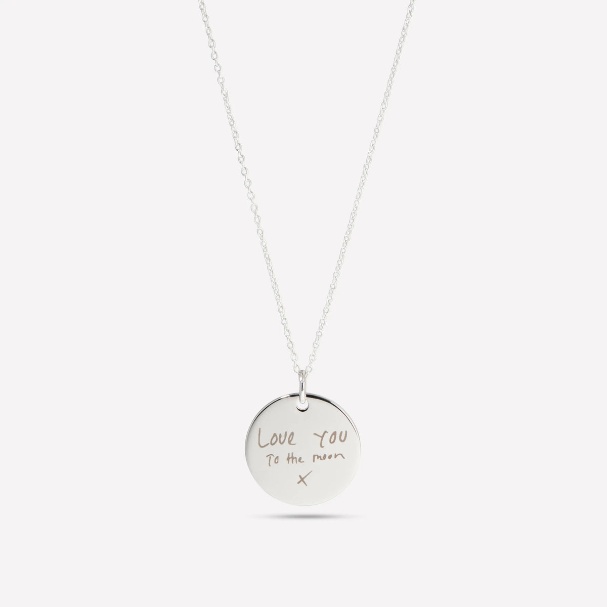 Silver disc pendant necklace engraved with a handwritten message