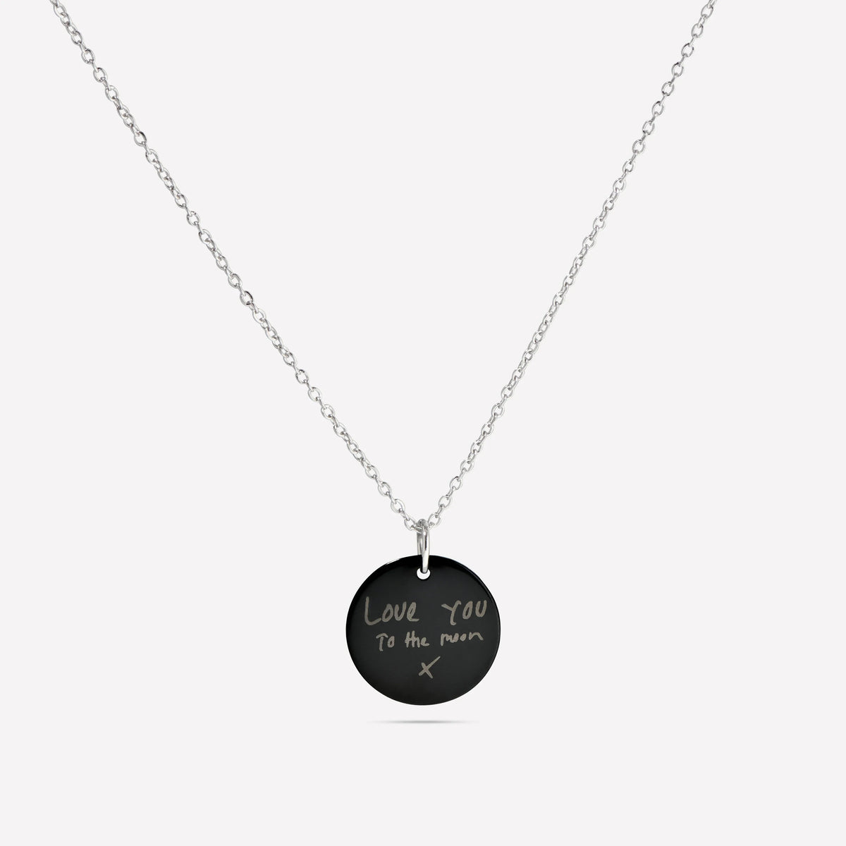Black disc pendant necklace engraved with a handwritten message
