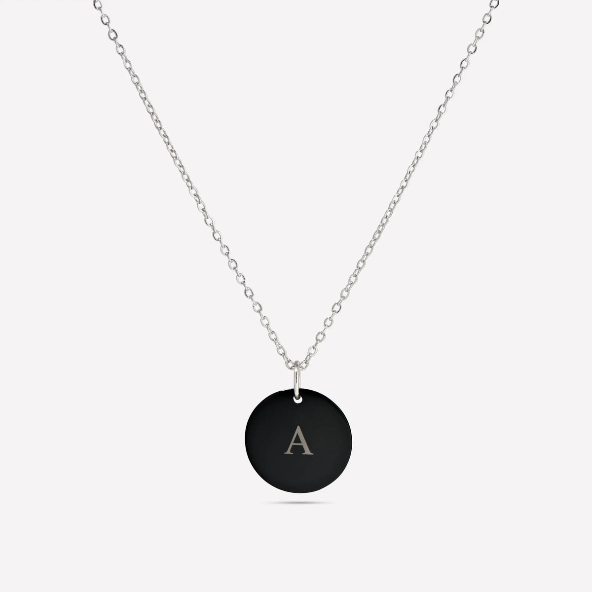 Black initial A pendant necklace on a white background