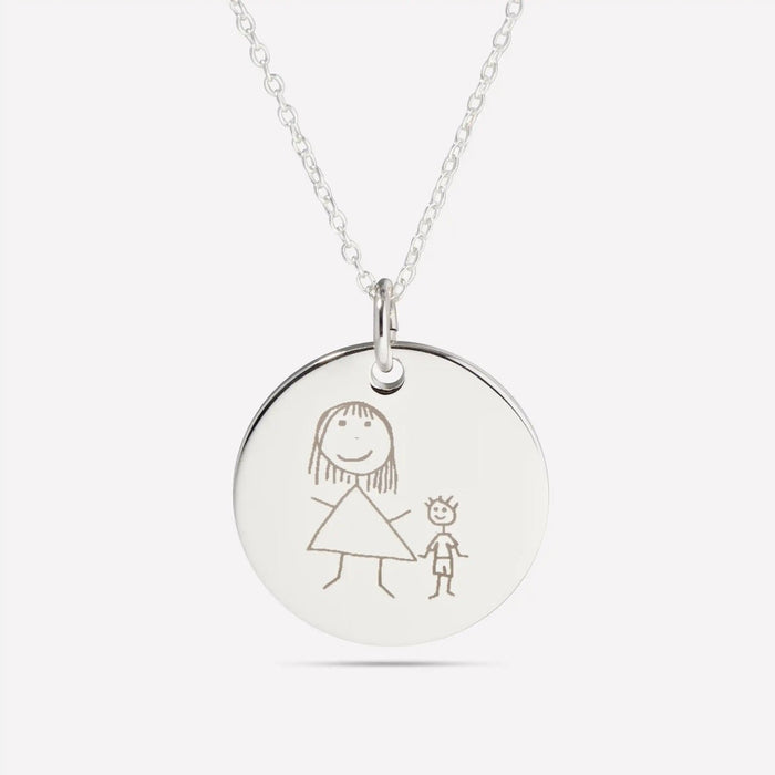 Silver pendant engraved with a child’s drawing