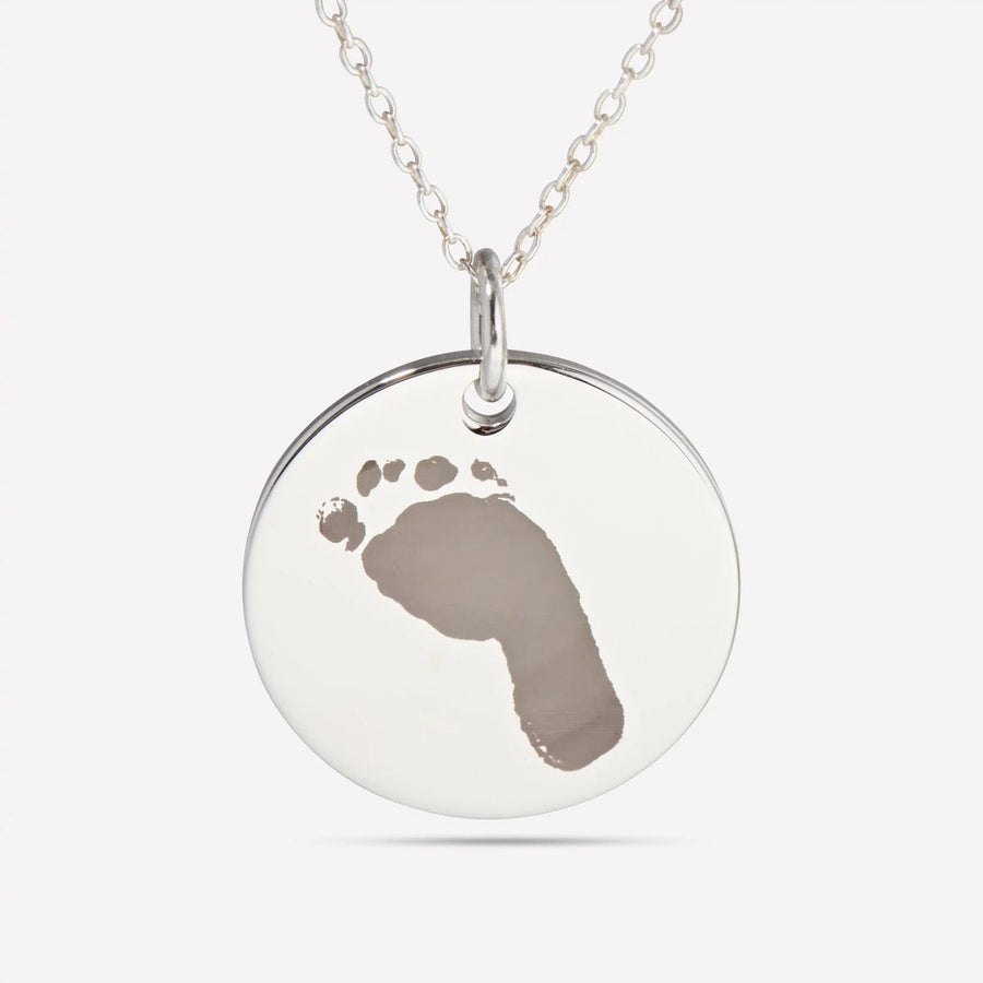 Silver pendant engraved with a baby footprint