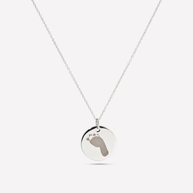 Silver pendant engraved with a baby footprint