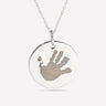 Silver pendant engraved with a child's handprint