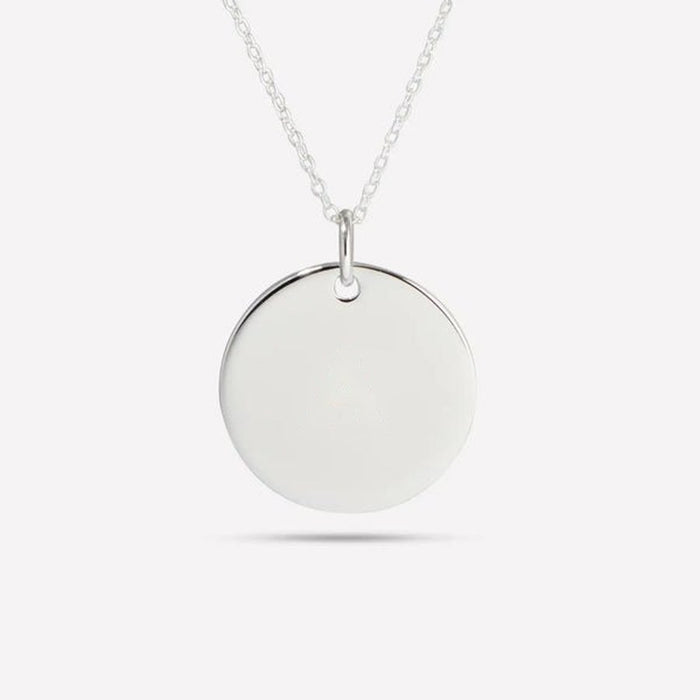 Blank round silver pendant on a chain, ready for engraving