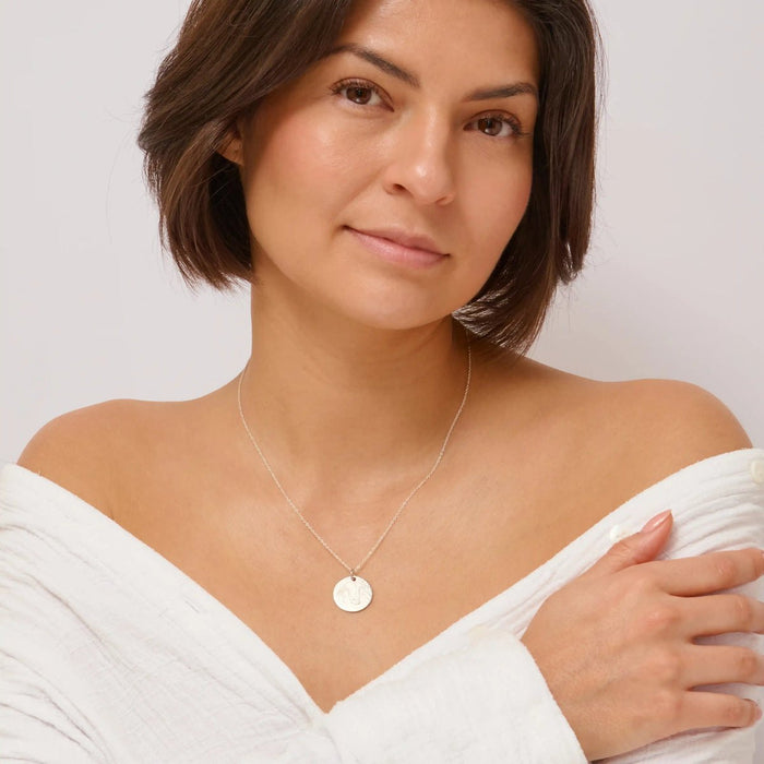 Woman wearing a silver street map necklace