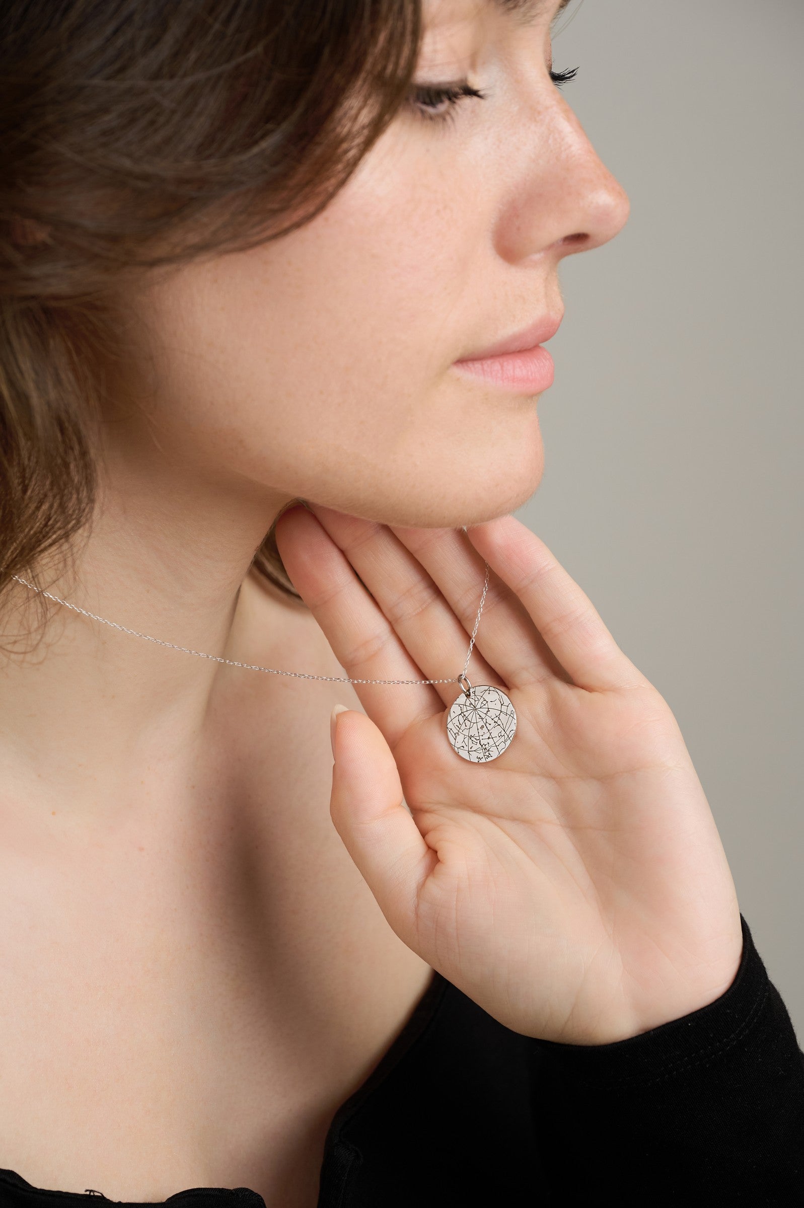 Silver pendant held