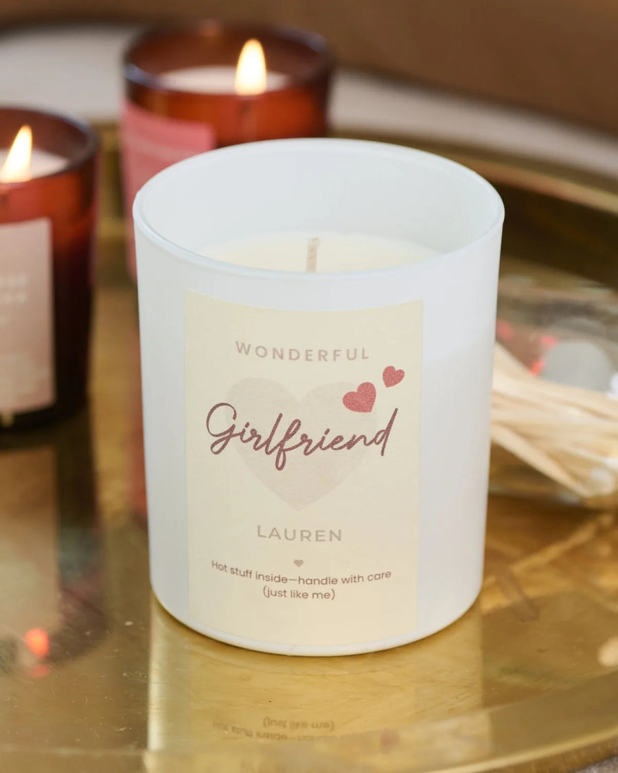 Lit personalised candles on a gold tray
